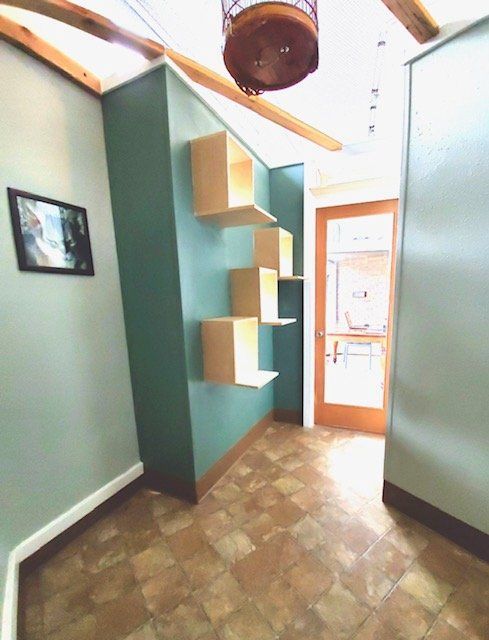 A hallway with shelves and a picture on the wall
