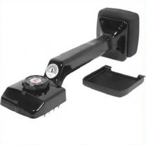 A black, handheld carpet stretcher with a spiked head, a tension adjustment dial, and a detached plastic guard plate.