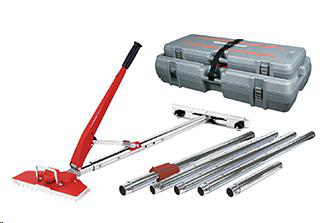 A carpet stretcher tool with red handles, several extension poles, and a grey carrying case on a white background.