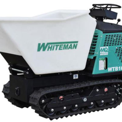 A green and white MQ Whiteman tracked power buggy with a large white material bucket on a dark undercarriage.