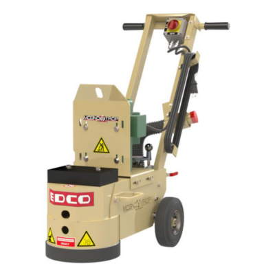 A tan EDCO floor grinder standing on wheels with a handle, motor housing, and safety warning labels.