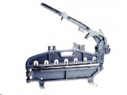A dark grey manual masonry or paver cutter tool with a lever handle and metal cutting blade, isolated on a white background.