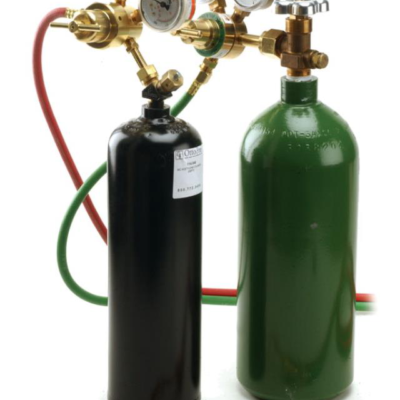 Two gas cylinders, one black and one green, equipped with pressure regulators and hoses for welding or industrial use.