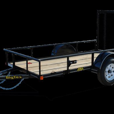 A black Big Tex utility trailer with a wooden deck and a raised rear gate, isolated against a black background.