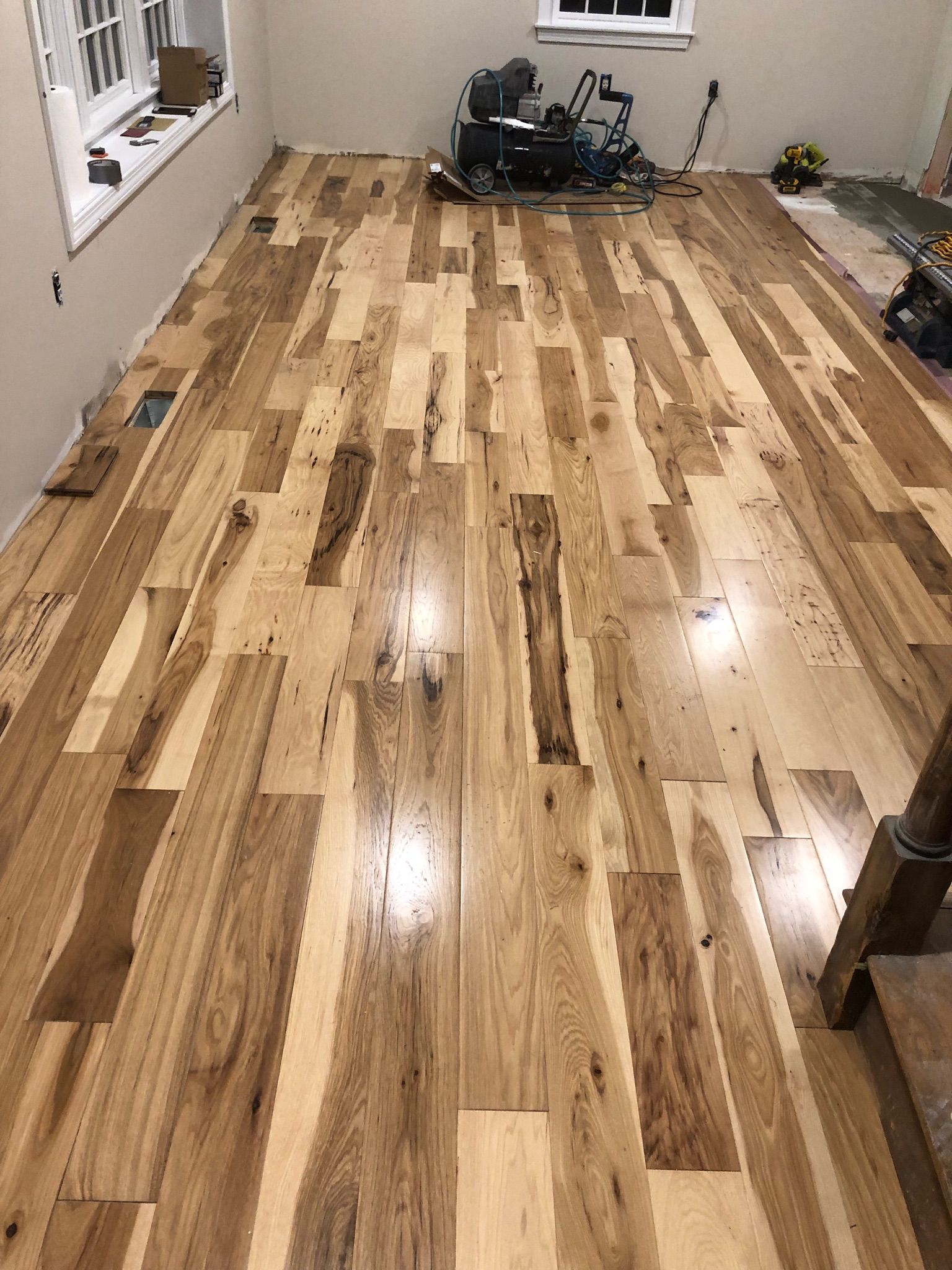 A room with hardwood floors and a window.