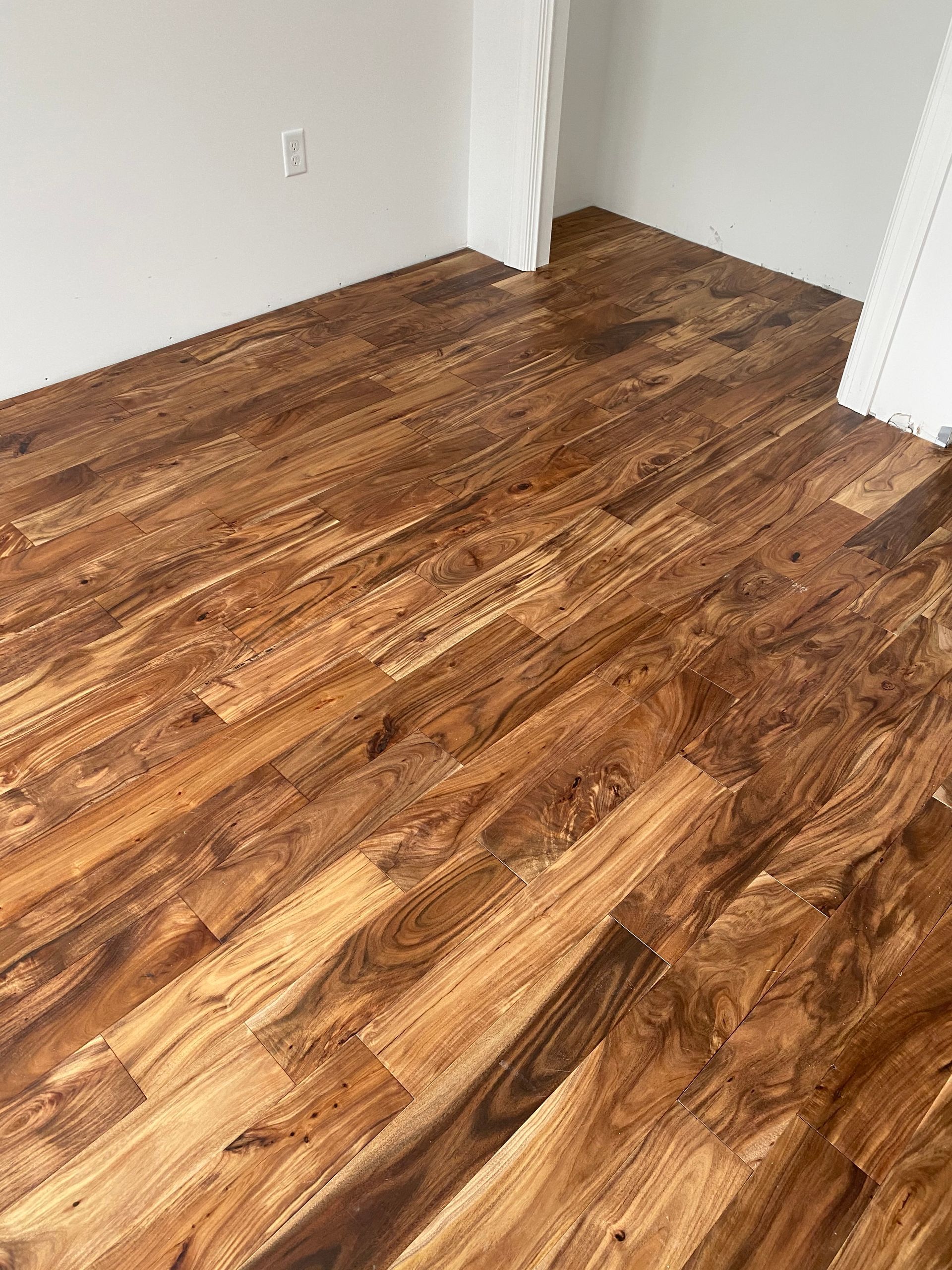 A room with a wooden floor and white walls.