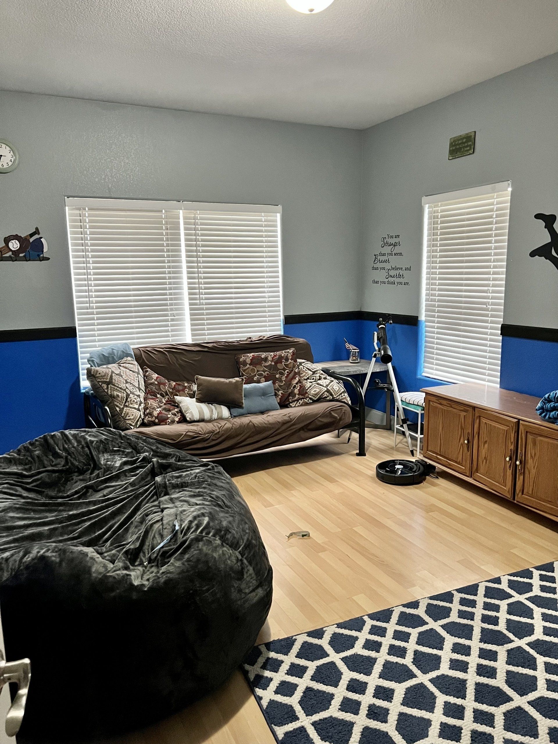 A living room with a couch and a bean bag chair.