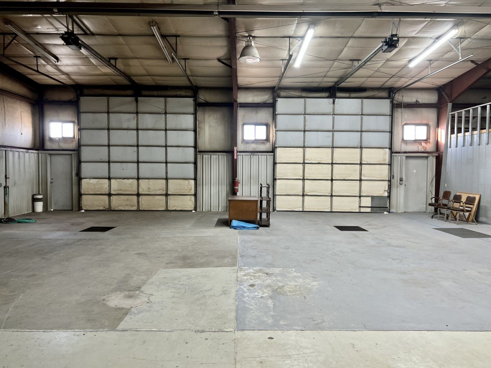 A large empty warehouse with a large garage door