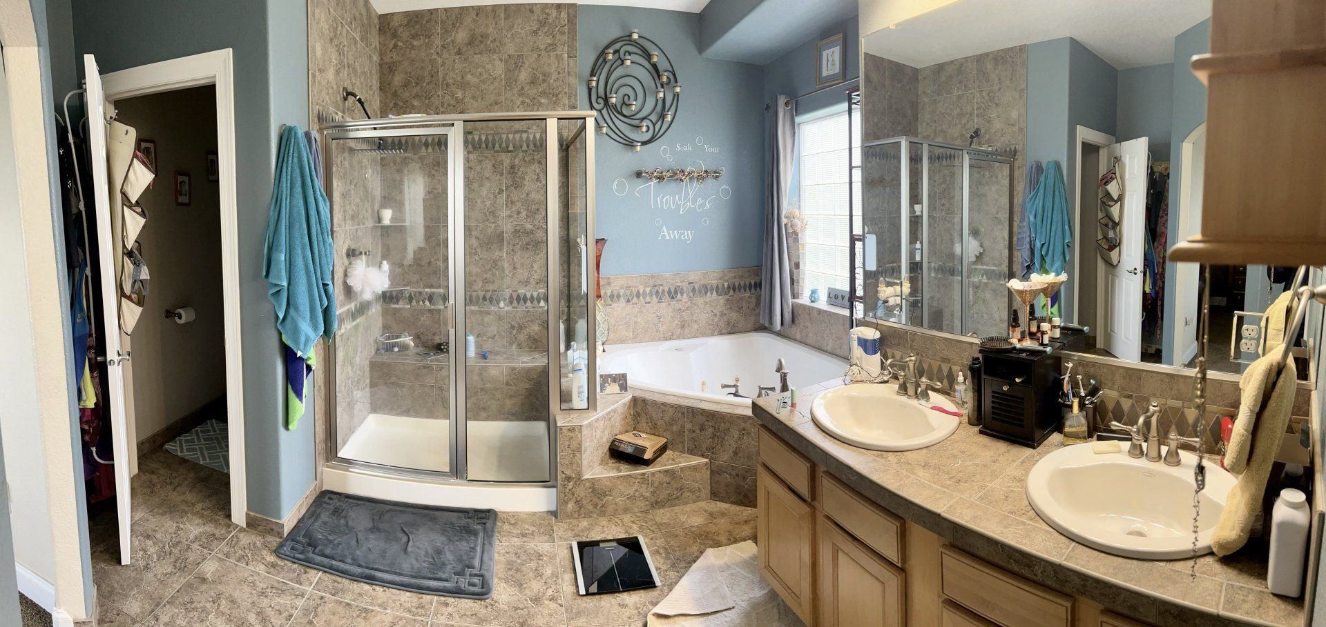 A bathroom with two sinks , a tub , a shower and a mirror.