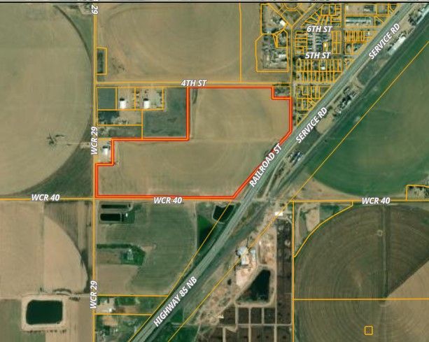 An aerial view of a farm with a road going through it