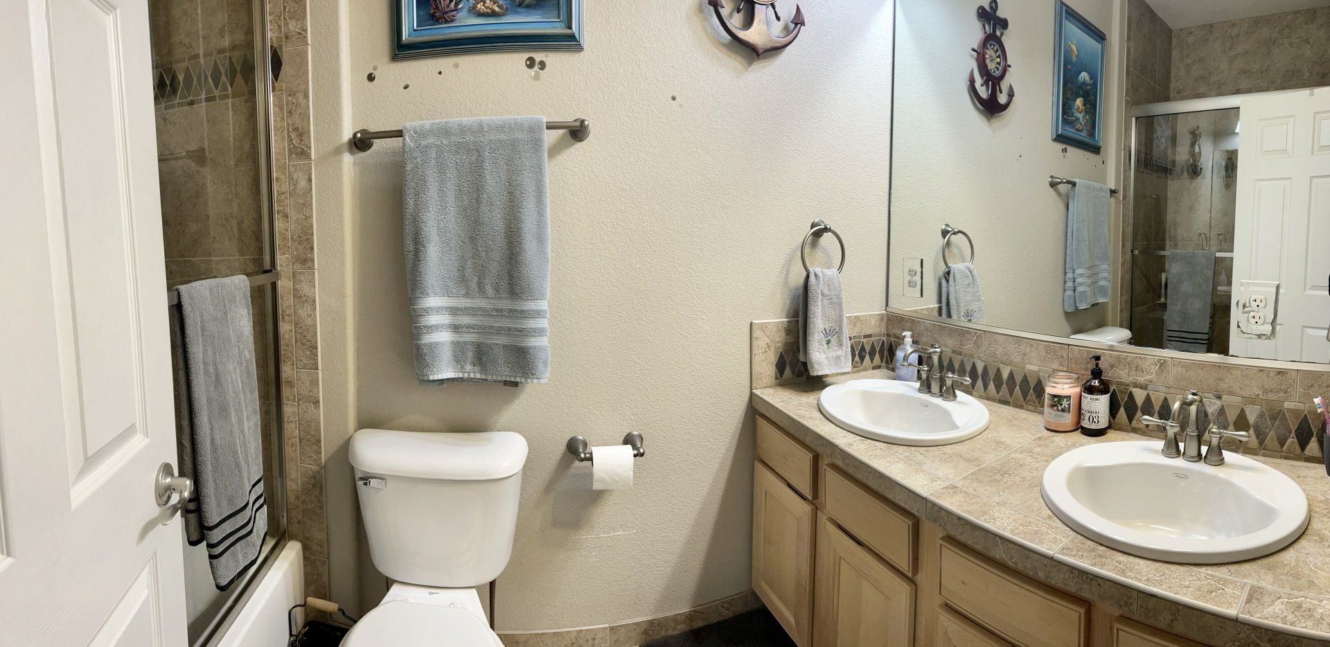 A bathroom with a toilet , sink , and shower.