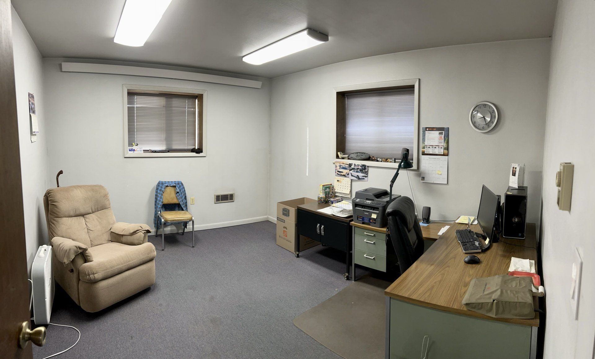 A room with a chair a desk and a computer