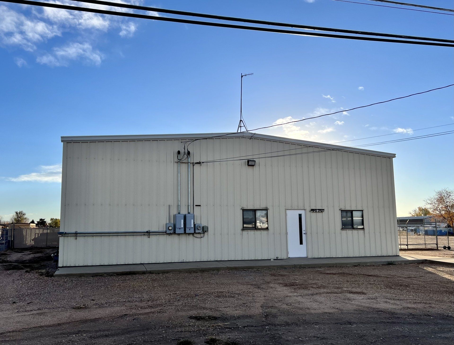 A white building with a blue sky in the background