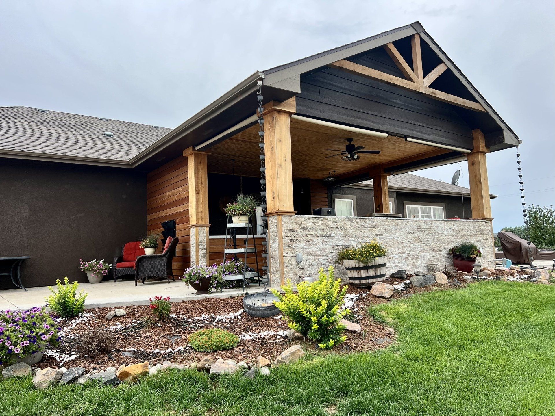 A house with a covered porch and a patio in front of it.