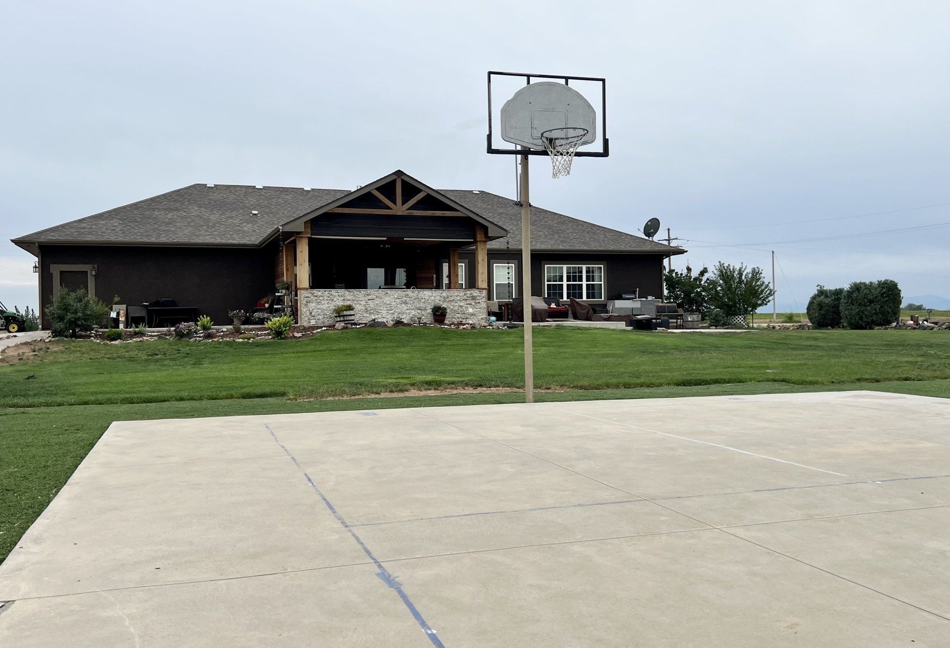 A large house with a basketball hoop in front of it