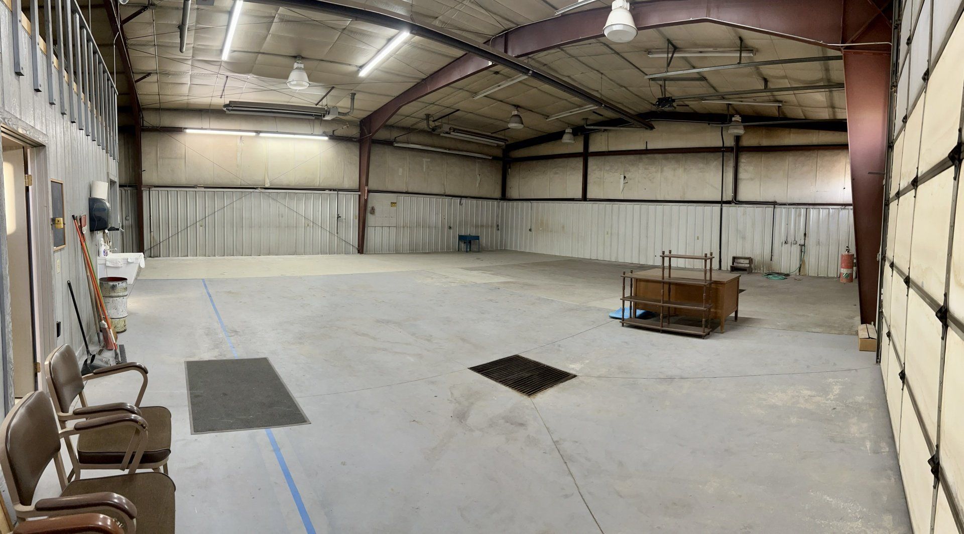 A large empty warehouse with a hole in the floor.
