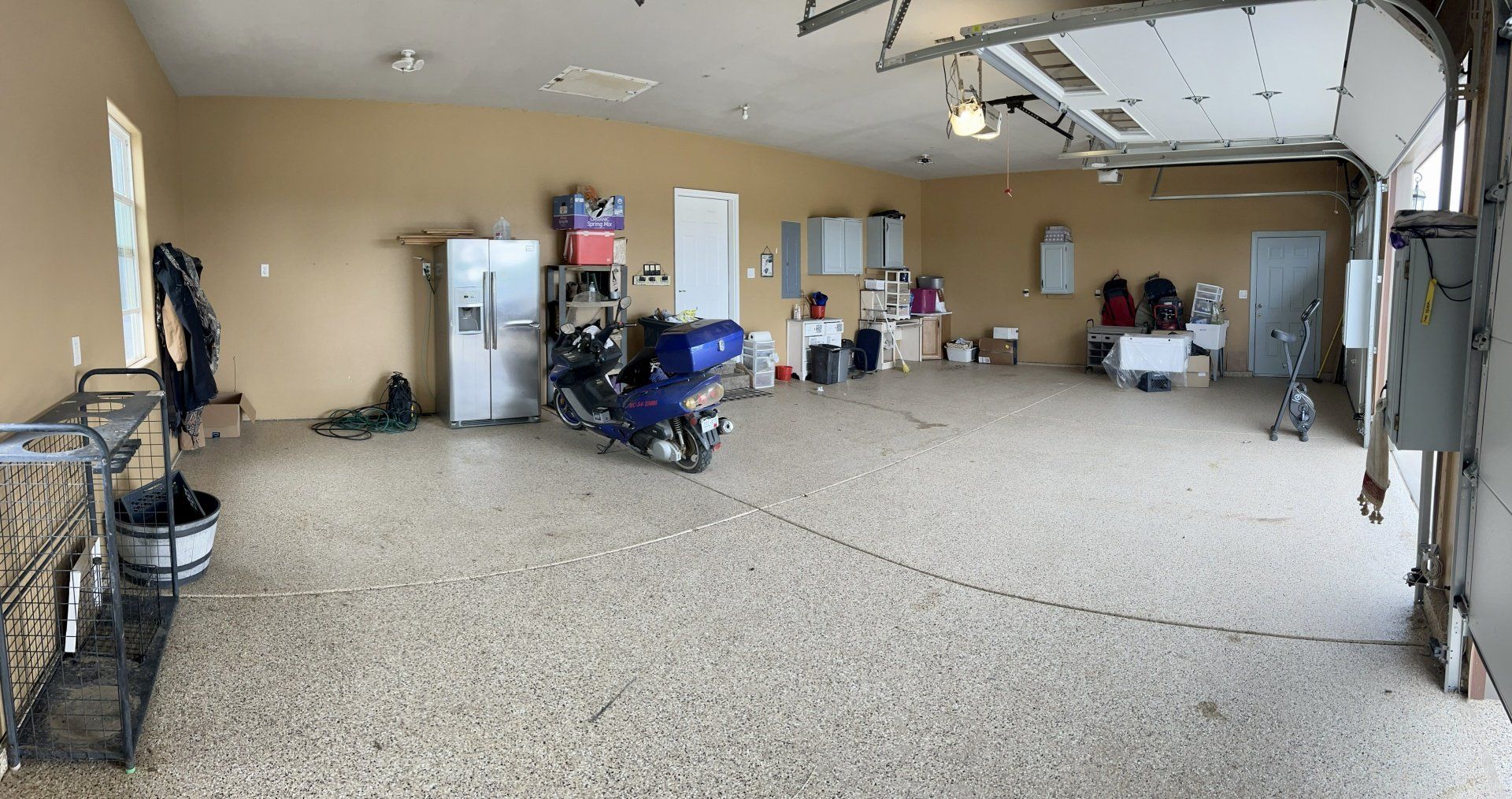 A large garage with a motorcycle parked in it