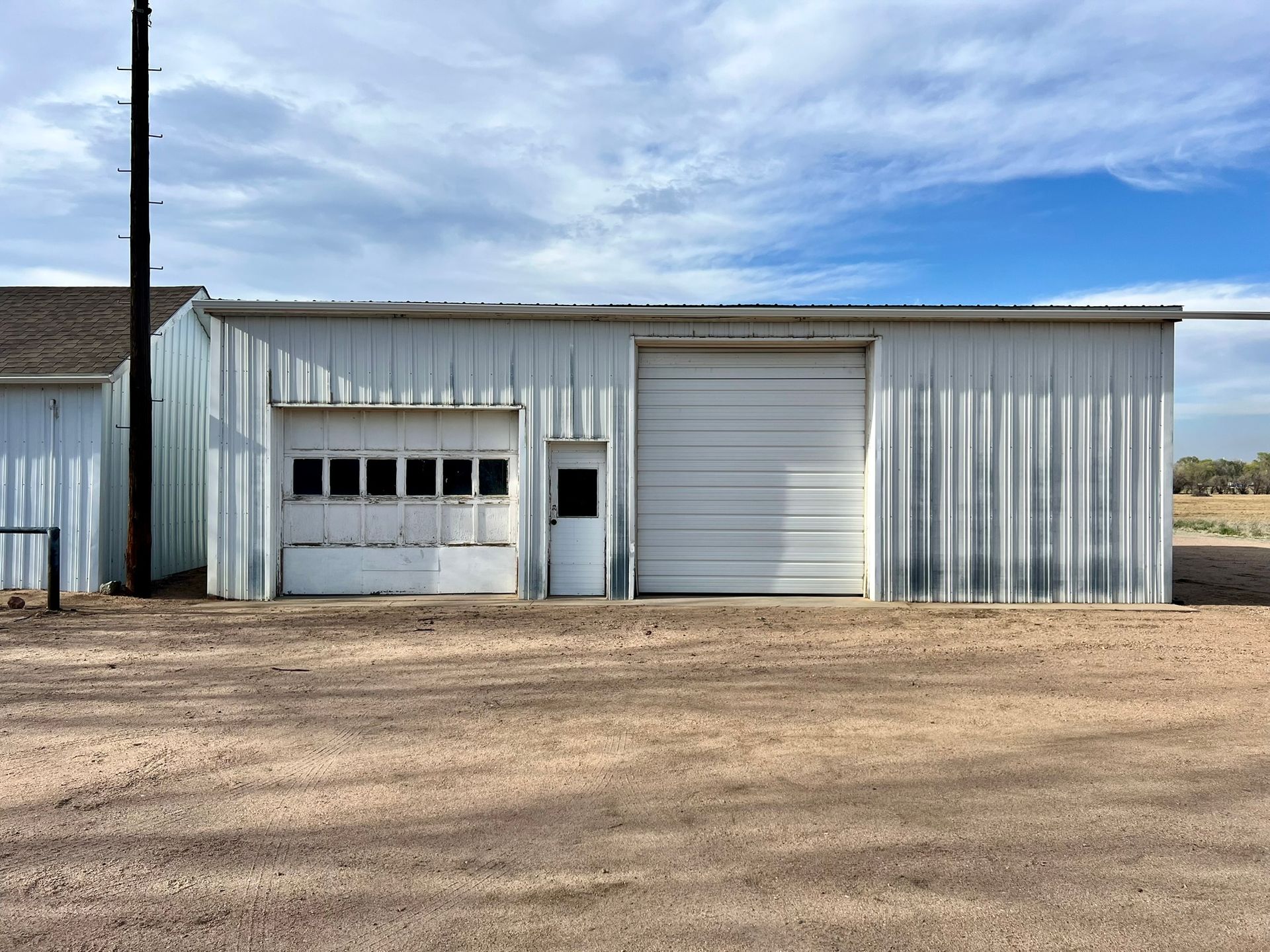 A white building with a white garage door