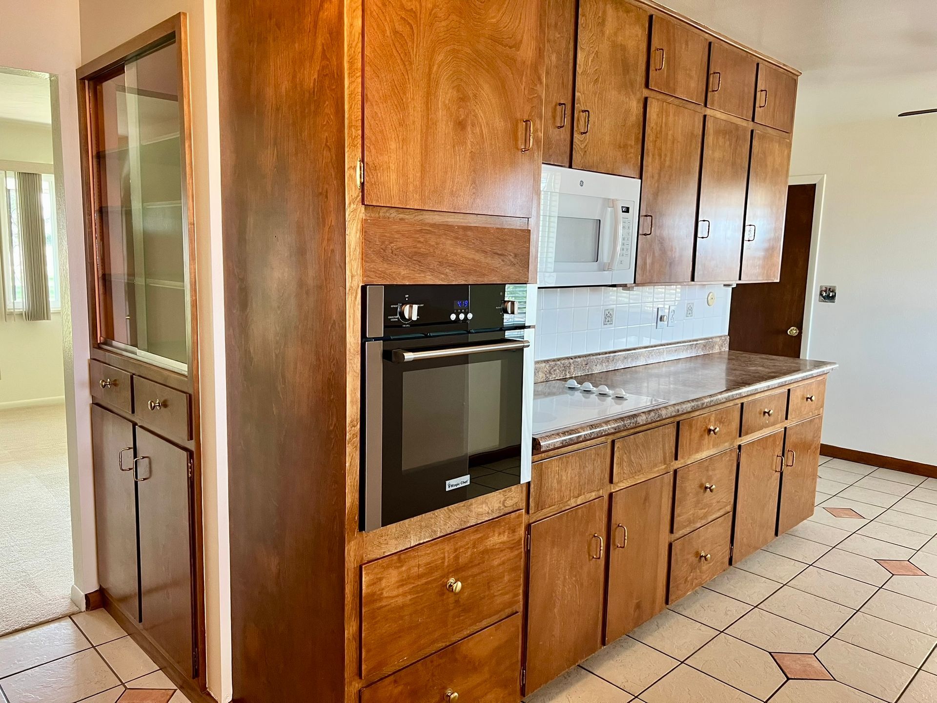 A kitchen with wooden cabinets and a black oven