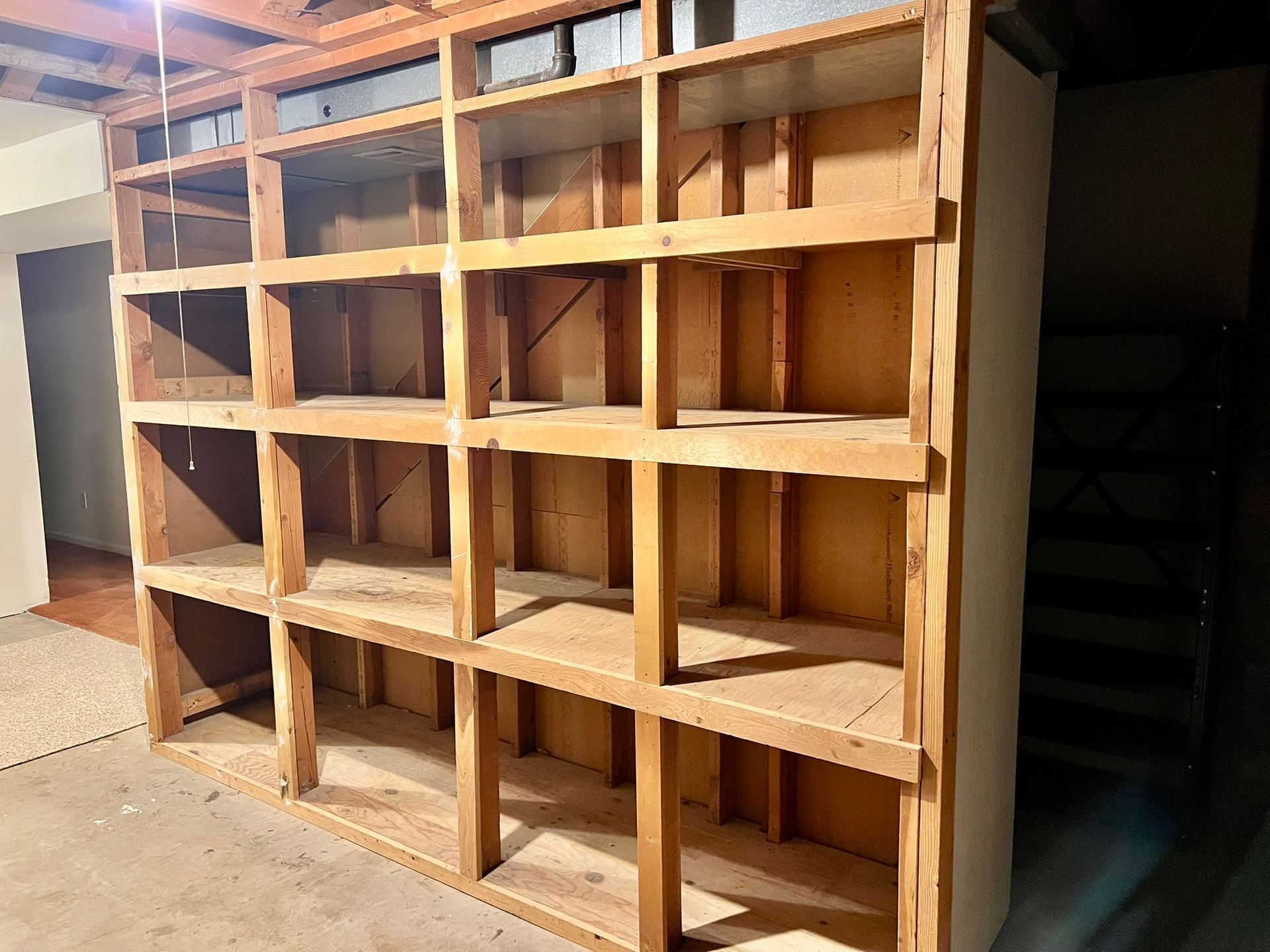 A large wooden shelf with lots of shelves in a room.