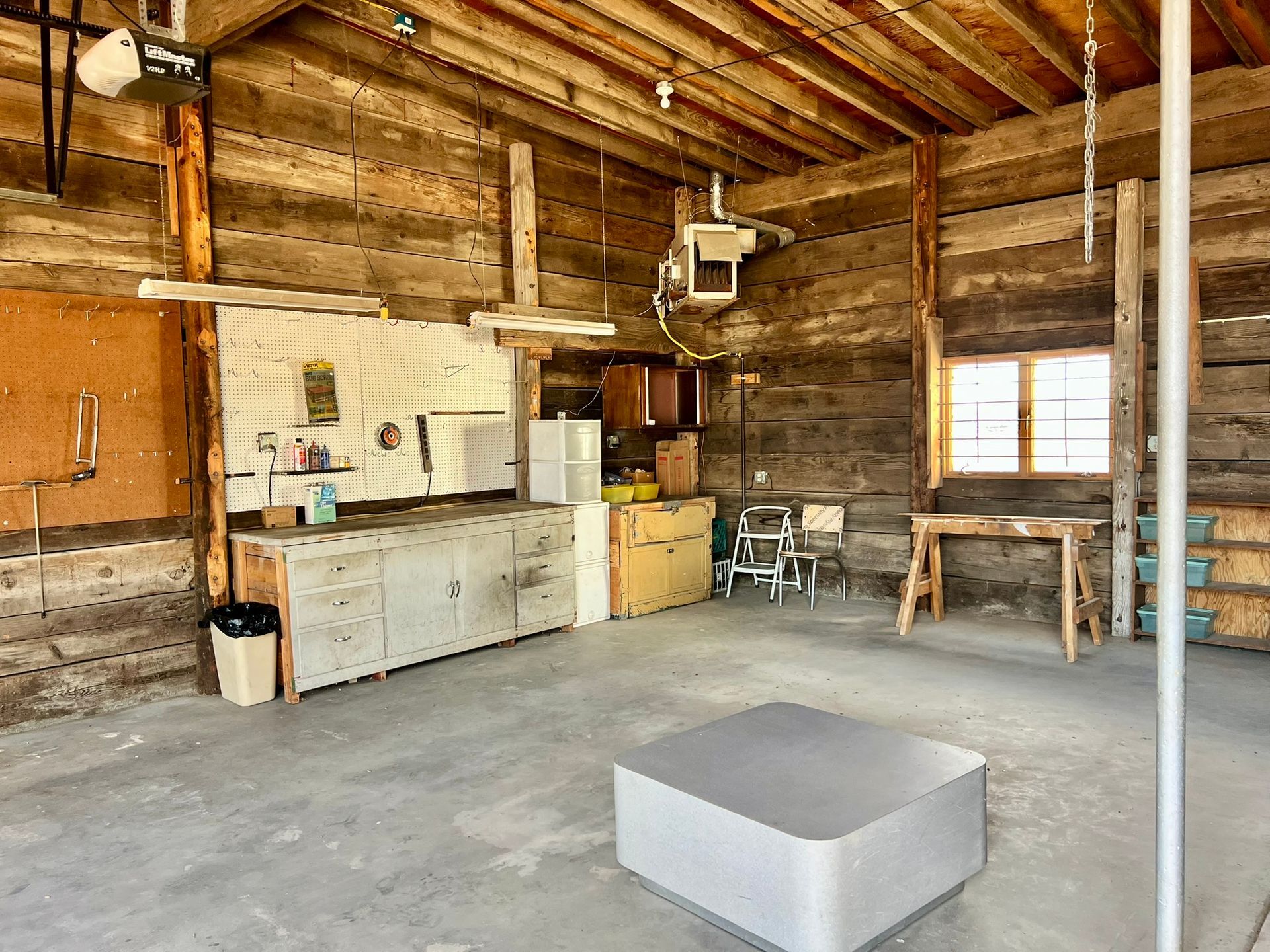 A large room with wooden walls and a concrete floor