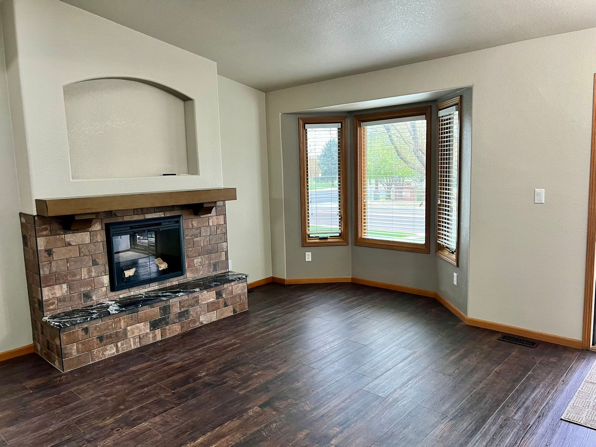 There is a fireplace in the middle of the living room.