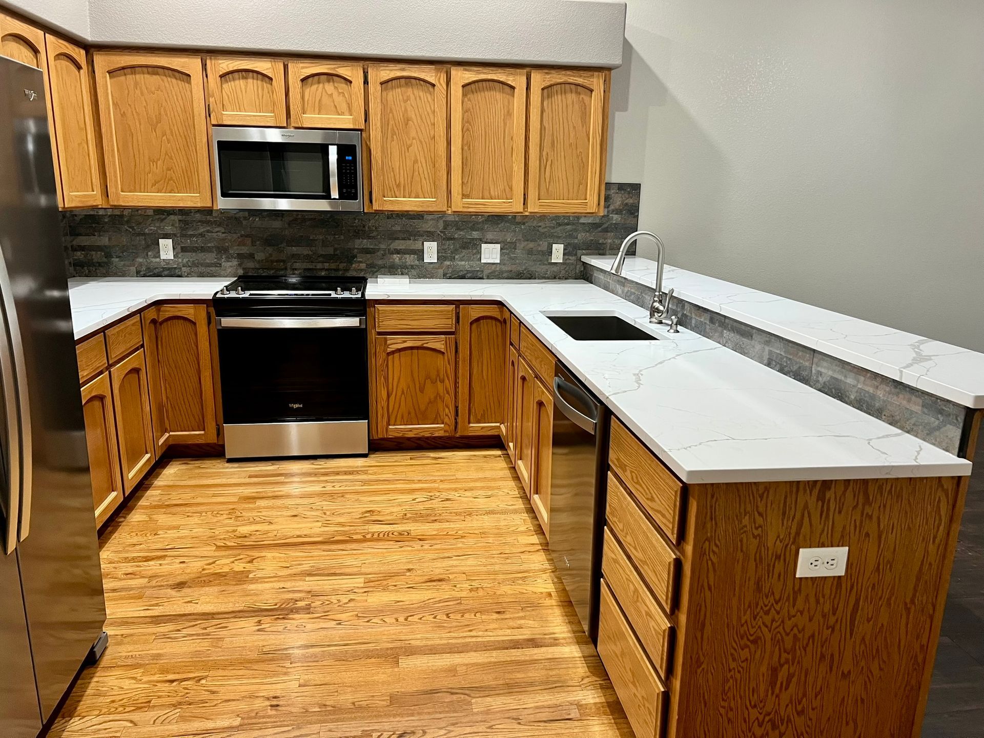 A kitchen with wooden cabinets and stainless steel appliances.