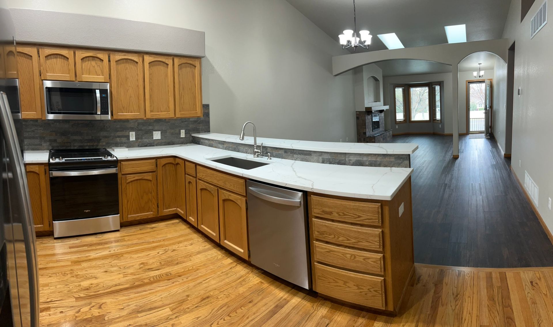 A kitchen with wooden cabinets and stainless steel appliances