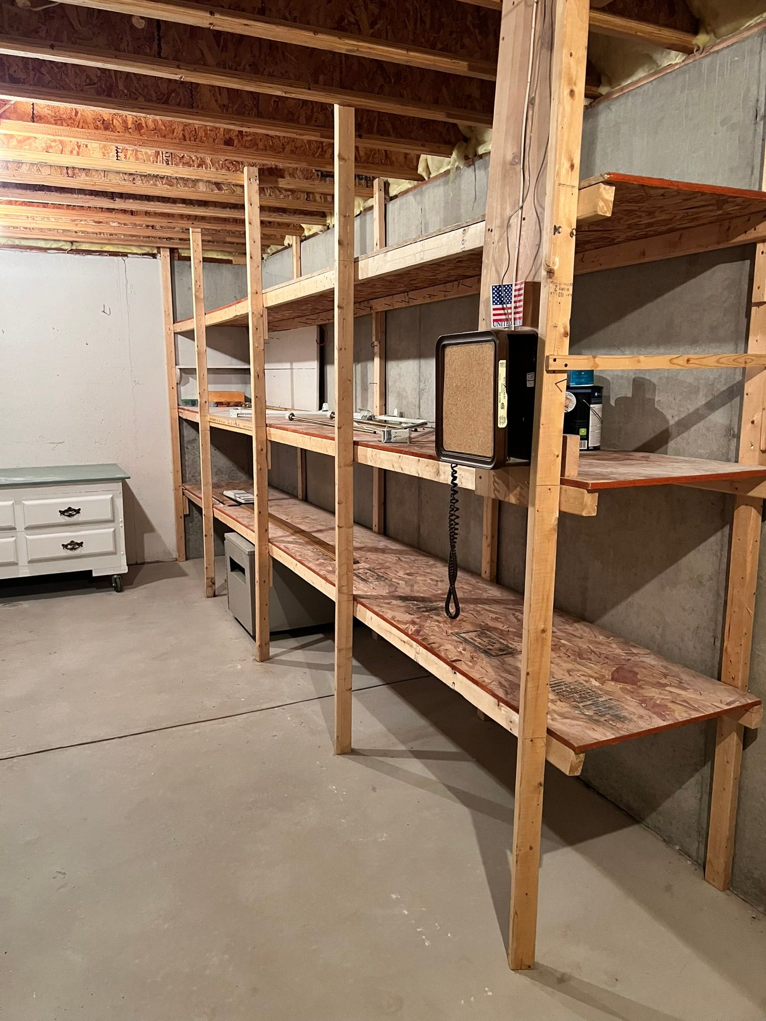 A row of wooden shelves in a basement.