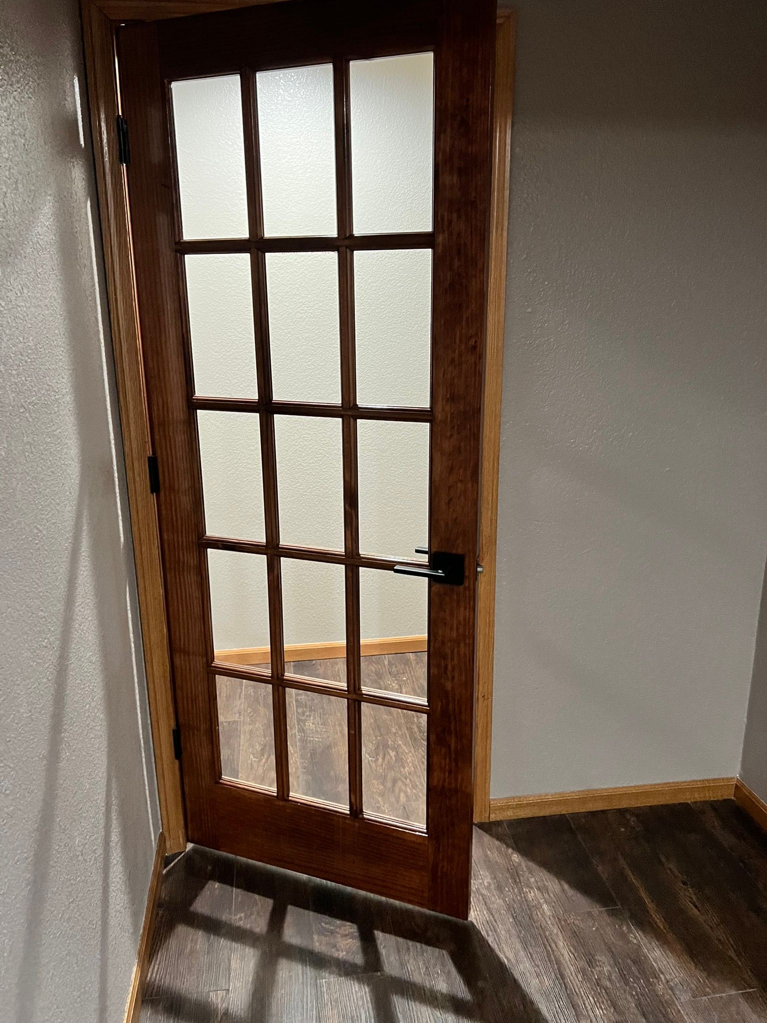 A wooden door with a glass window in a room