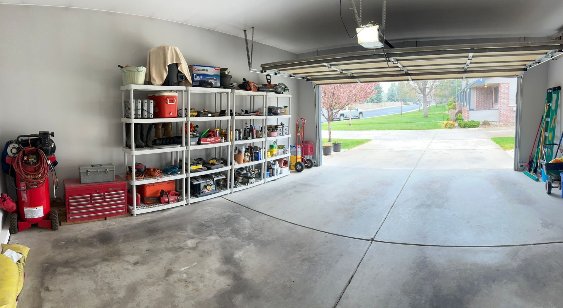 A garage filled with lots of tools and shelves.