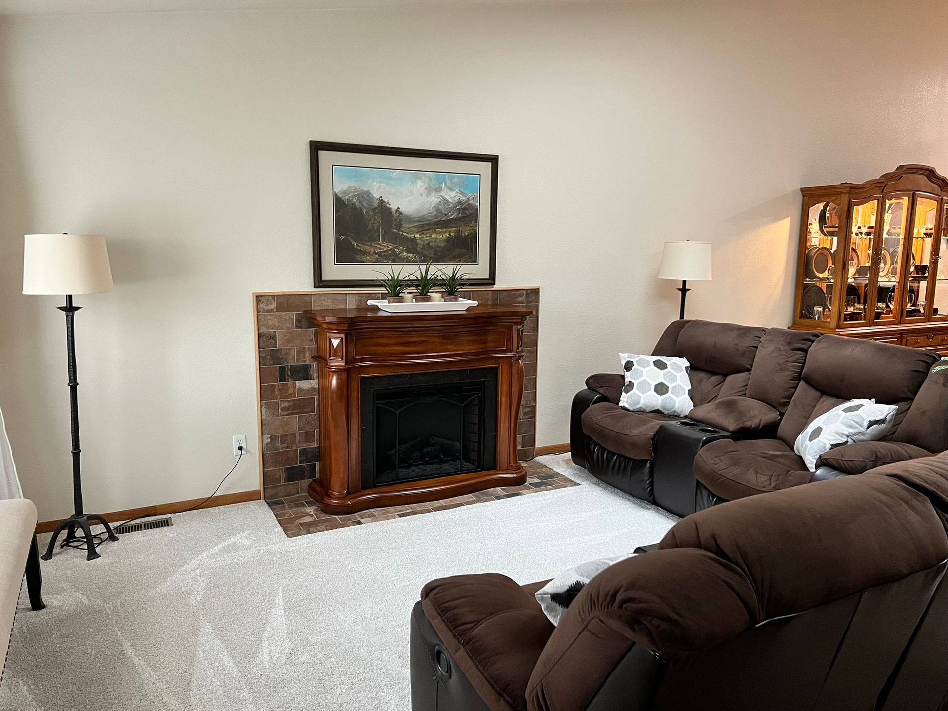 A living room with a couch and a fireplace