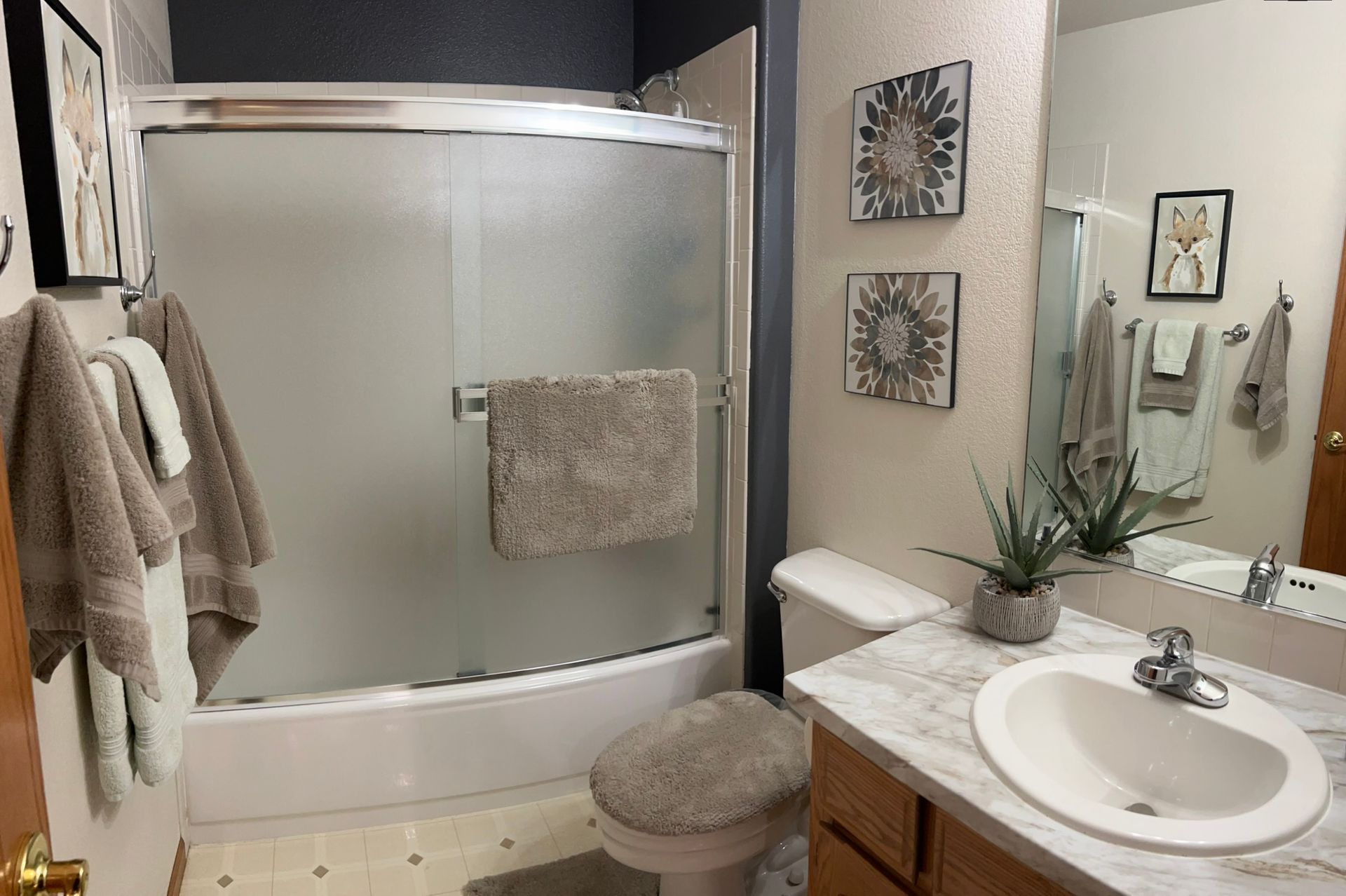 A bathroom with a toilet , sink , and shower.