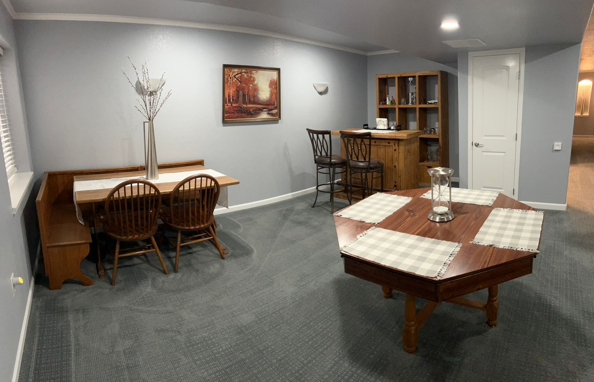 A room with a table and chairs in it