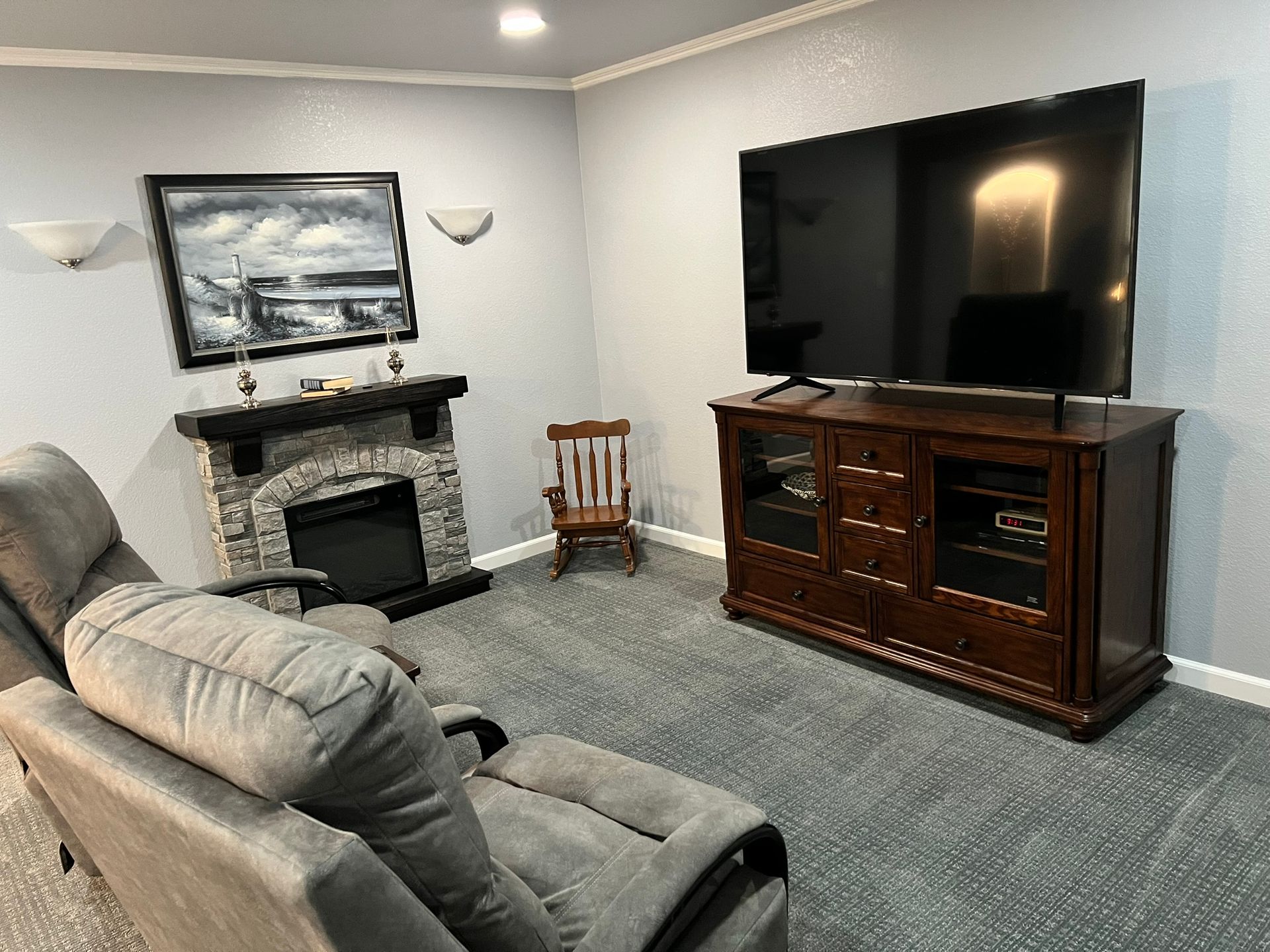 A living room with a fireplace and a flat screen tv.