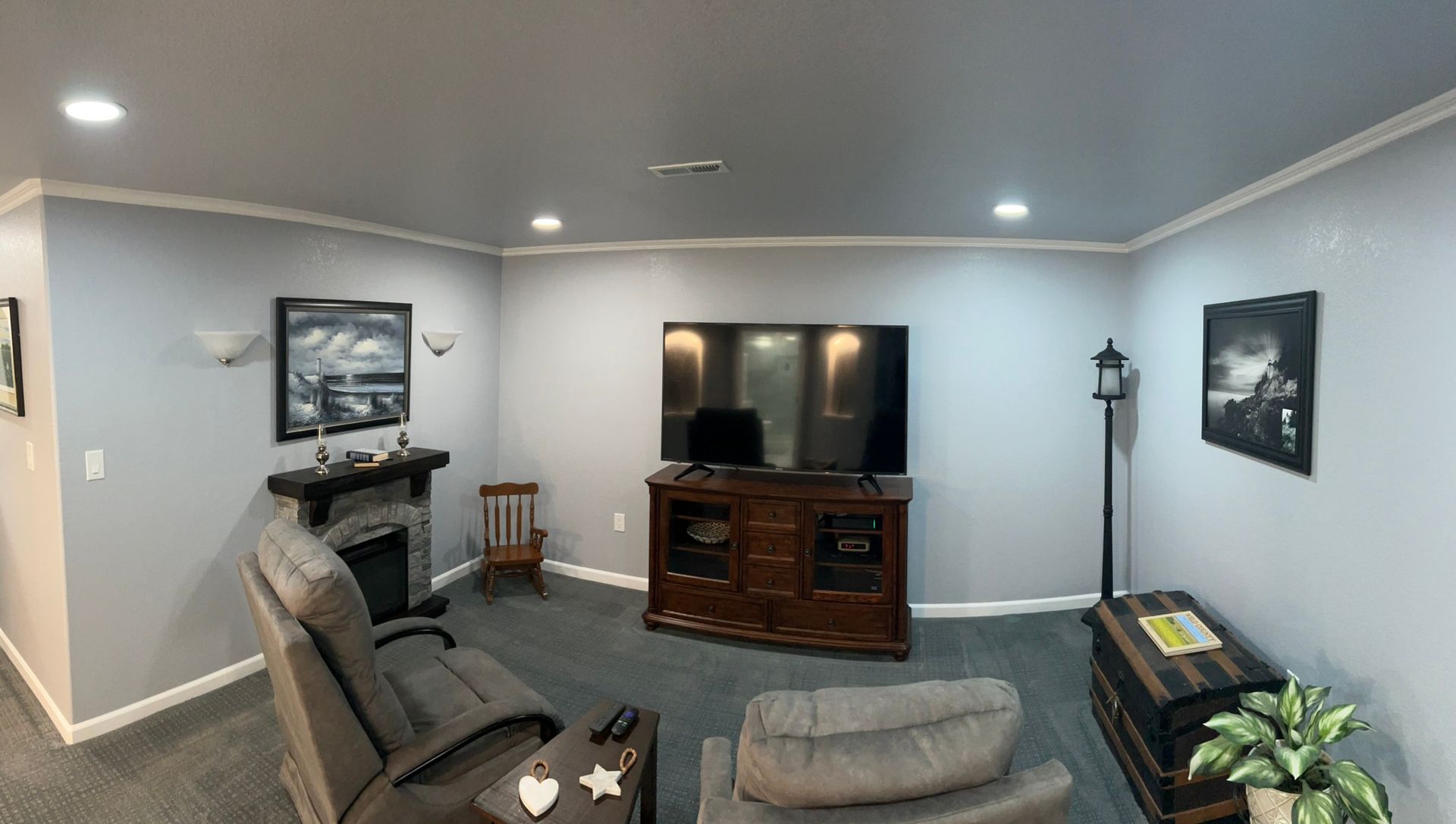 A living room with a fireplace and a flat screen tv.