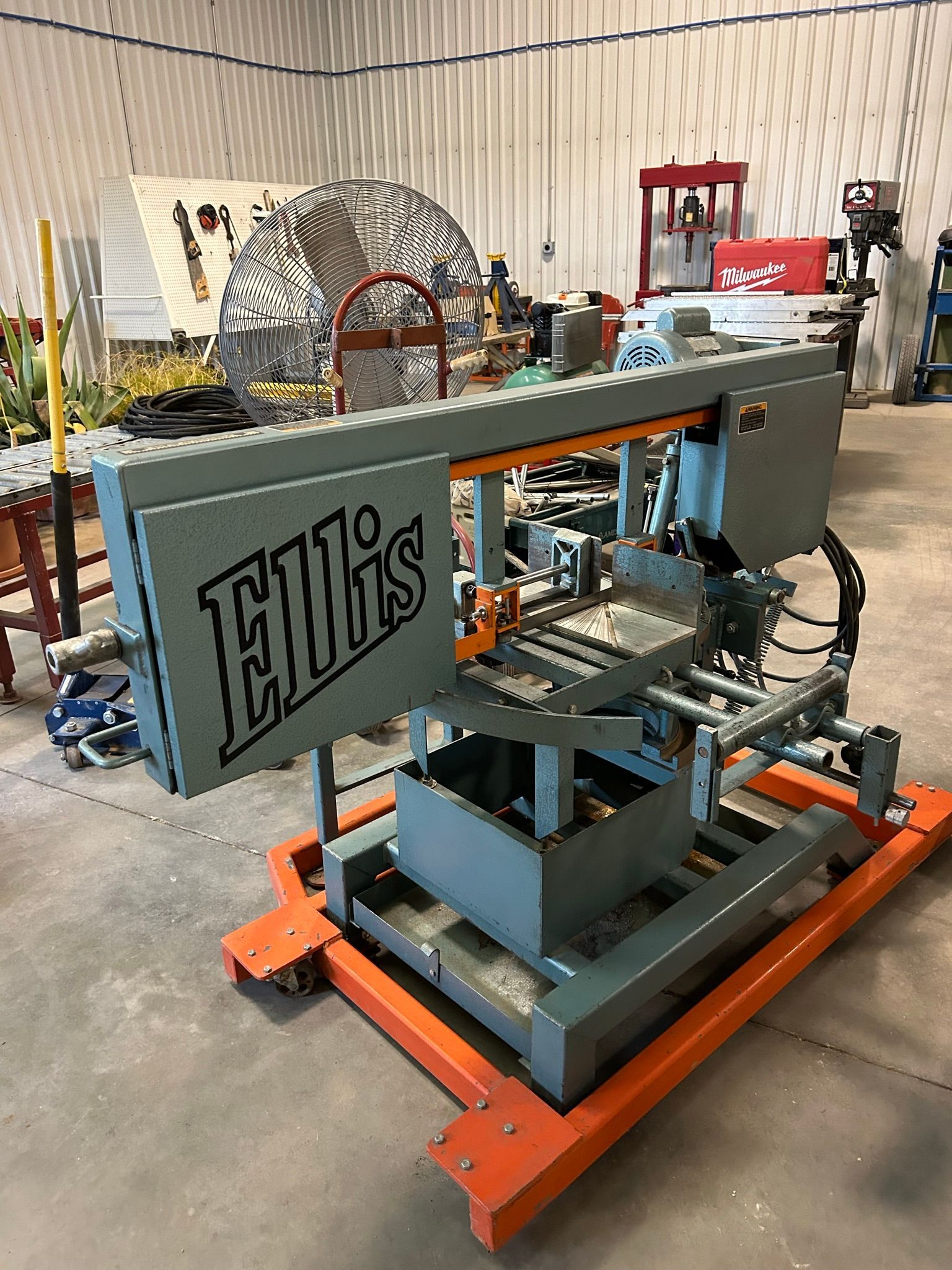 A machine is sitting on a cart in a warehouse.