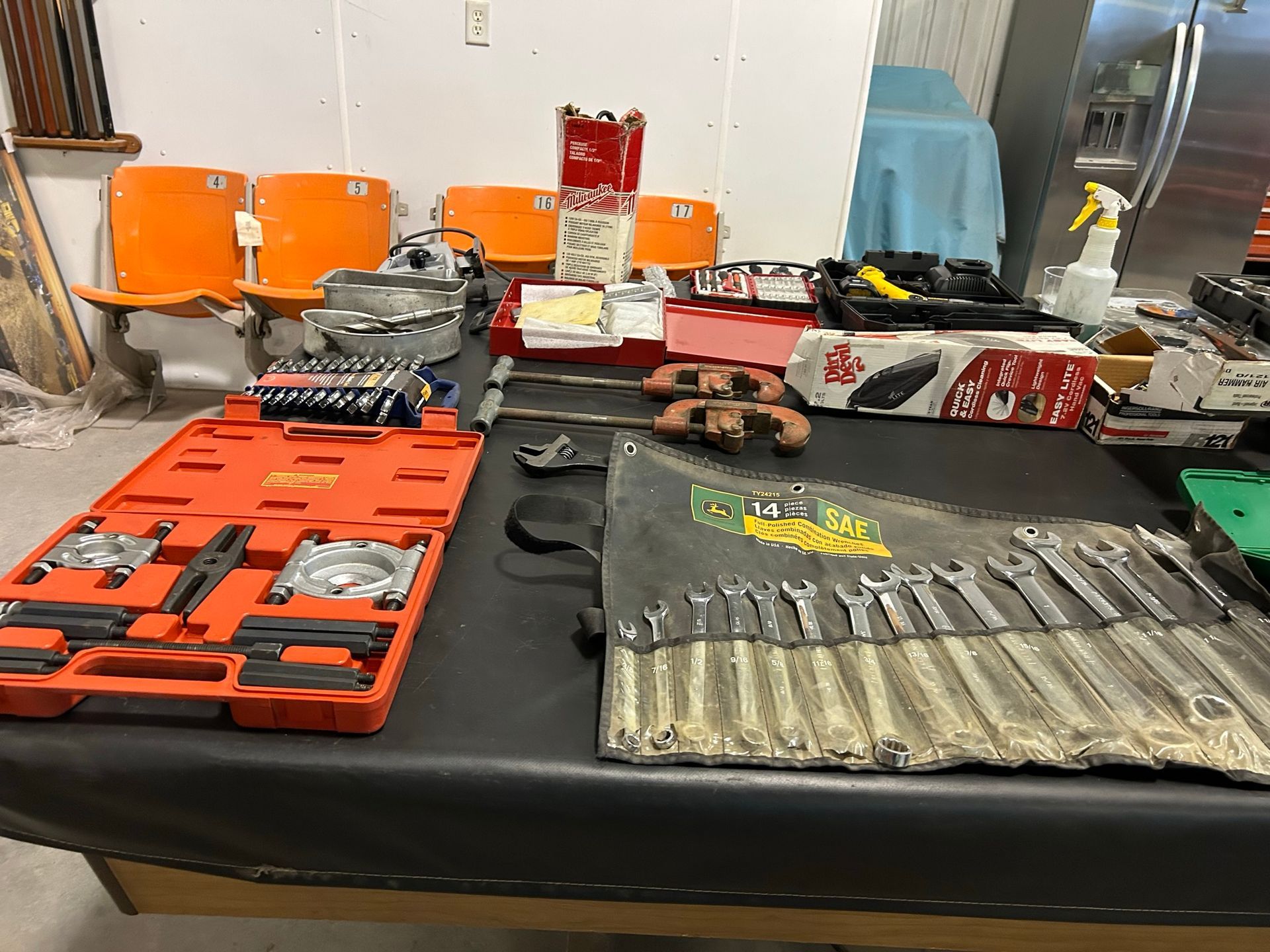 A table with a bunch of tools on it in a room.