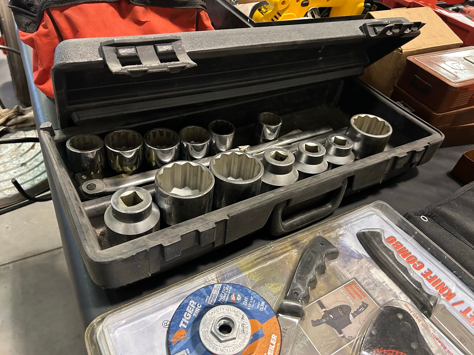 A toolbox filled with sockets and a disc.