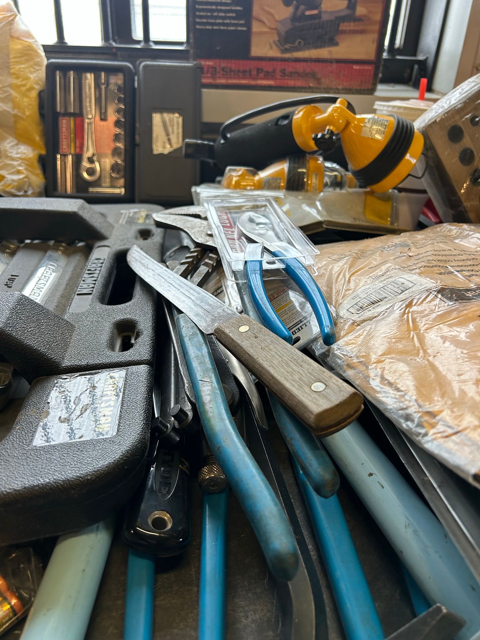A bunch of tools are sitting on top of each other on a table.