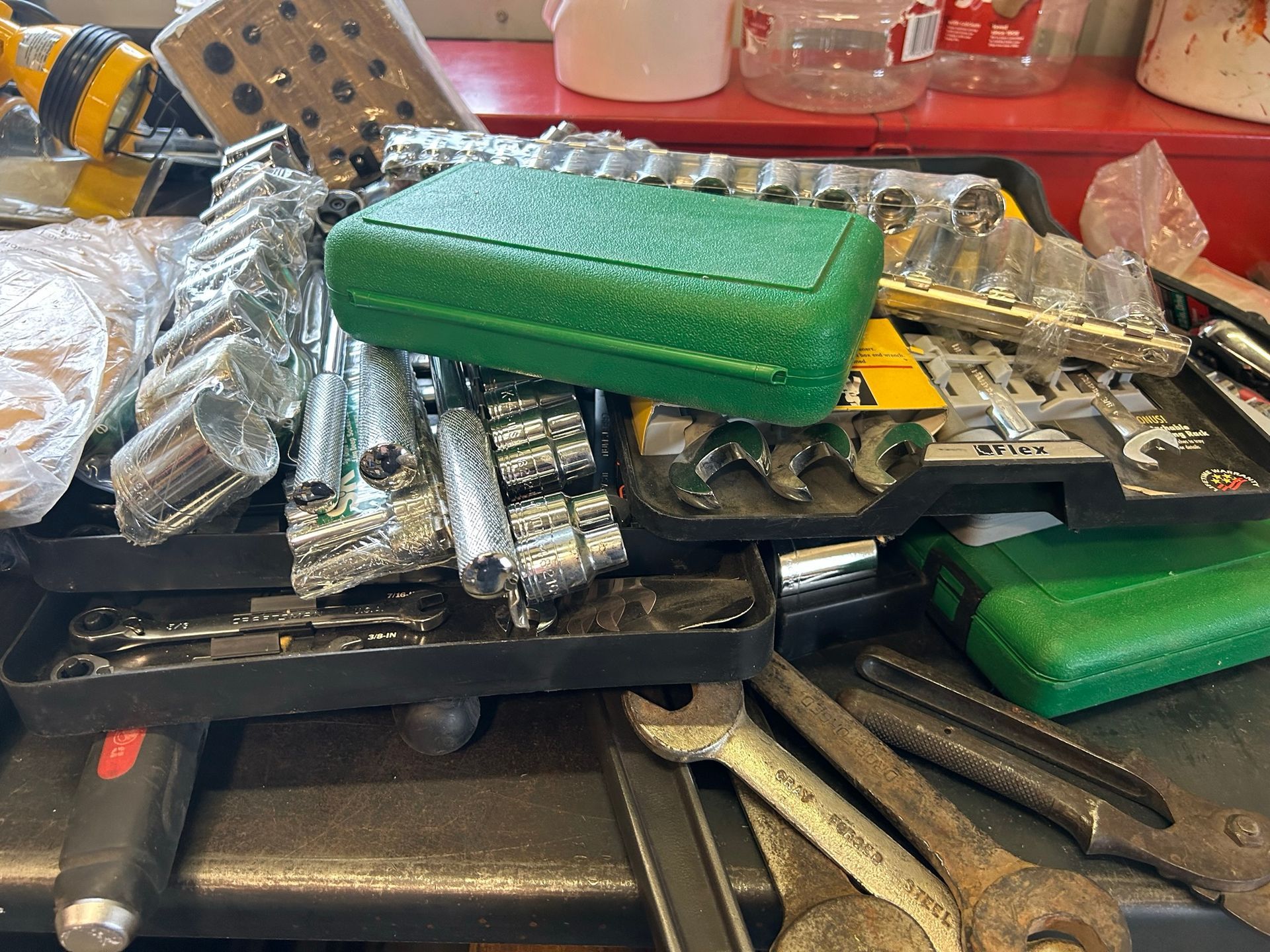 A bunch of tools are sitting on top of each other on a table.