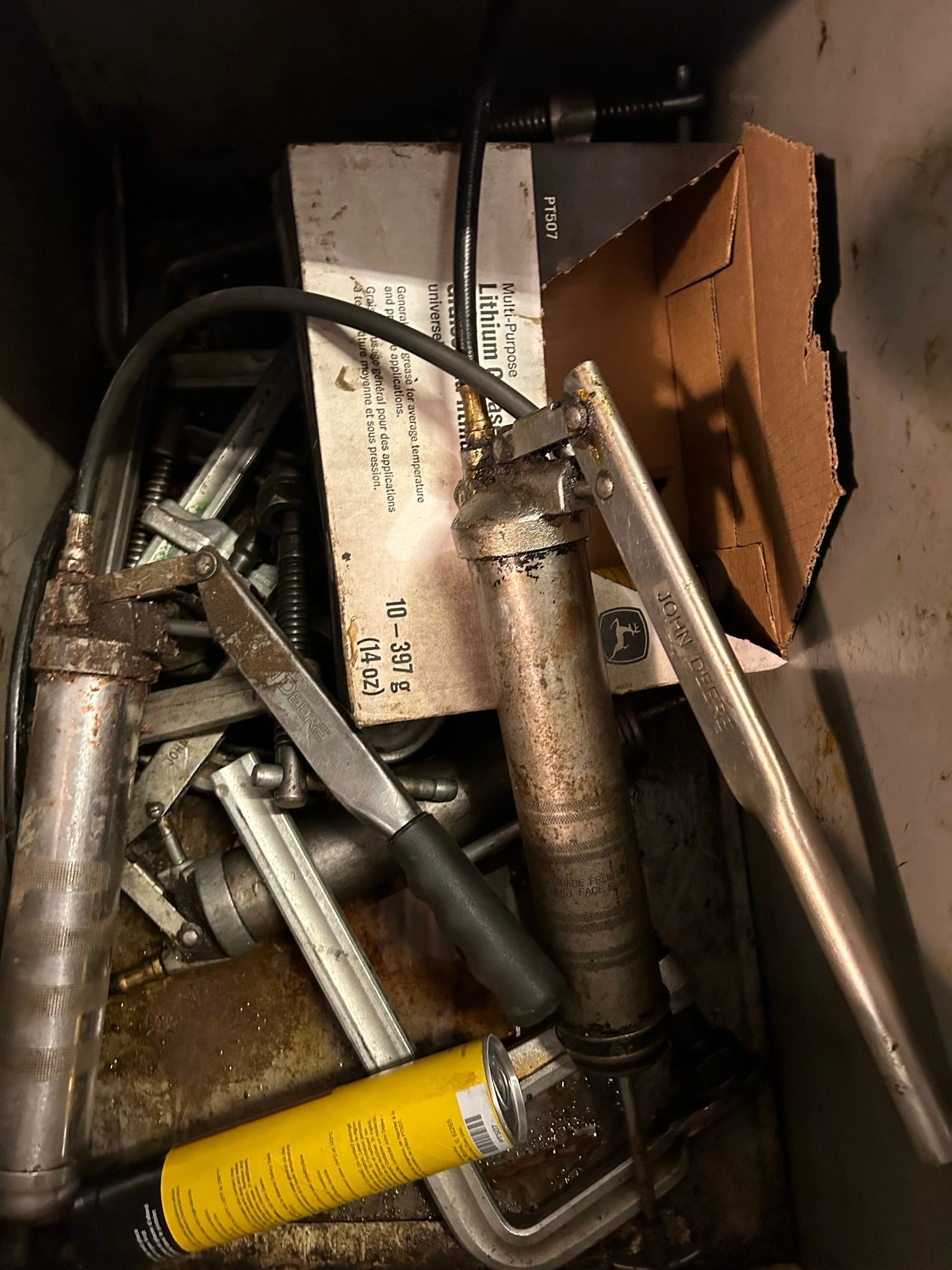 A bunch of tools are sitting on top of each other in a box.