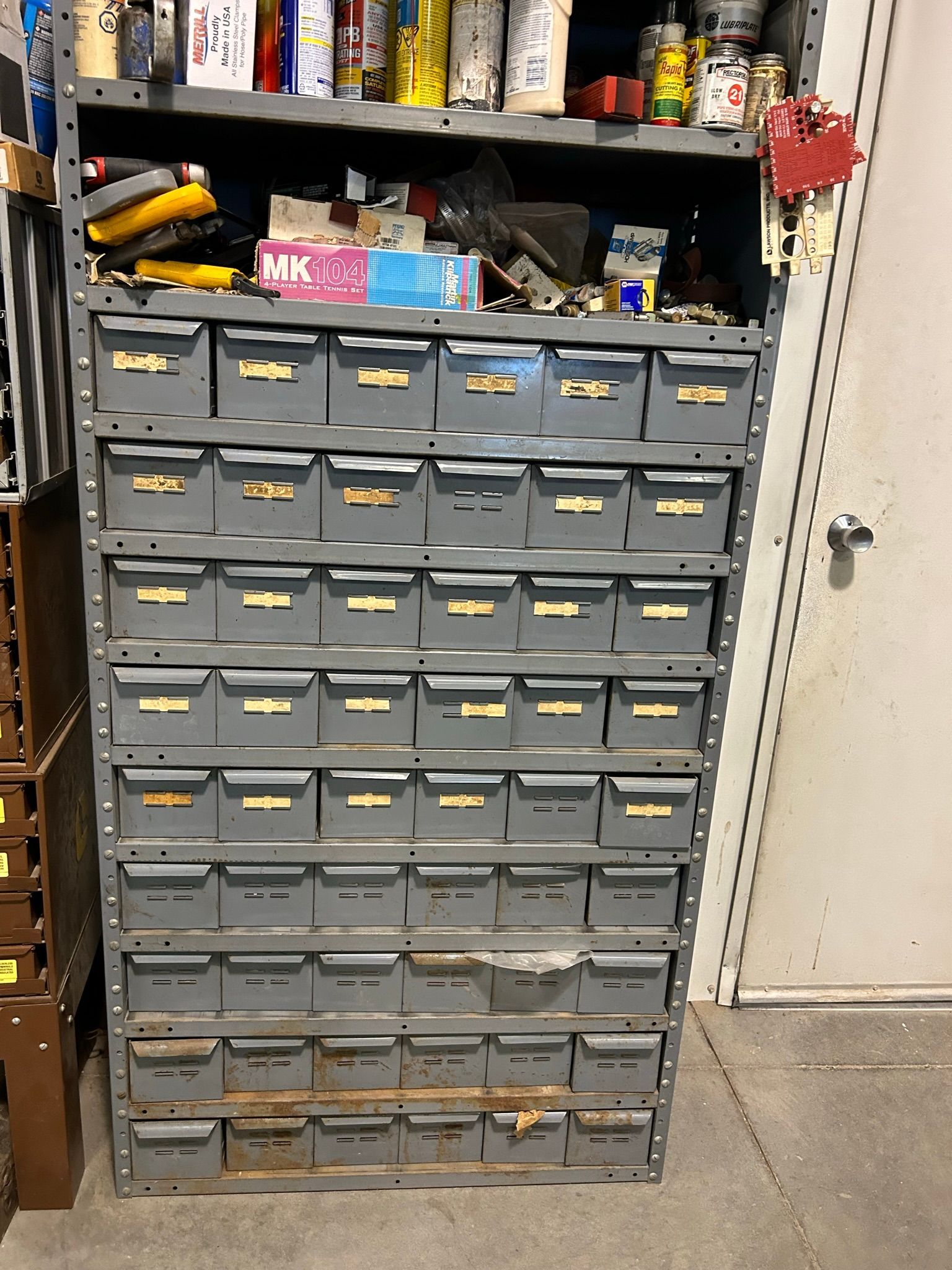 A shelf filled with lots of drawers and a box that says mk on it