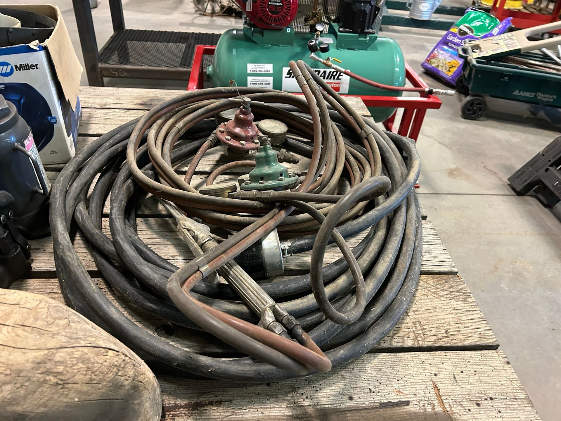 A bunch of tools are sitting on a wooden table.