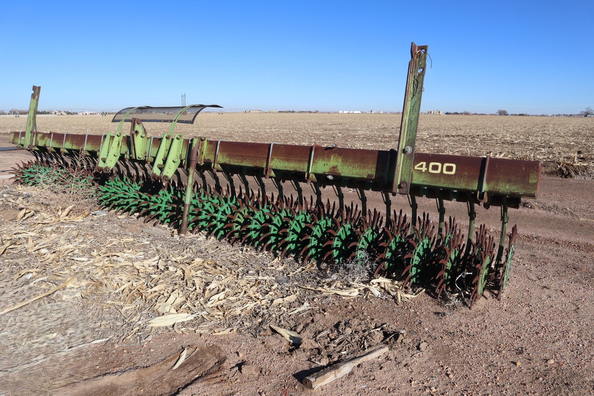 A john deere plow is sitting in the middle of a field