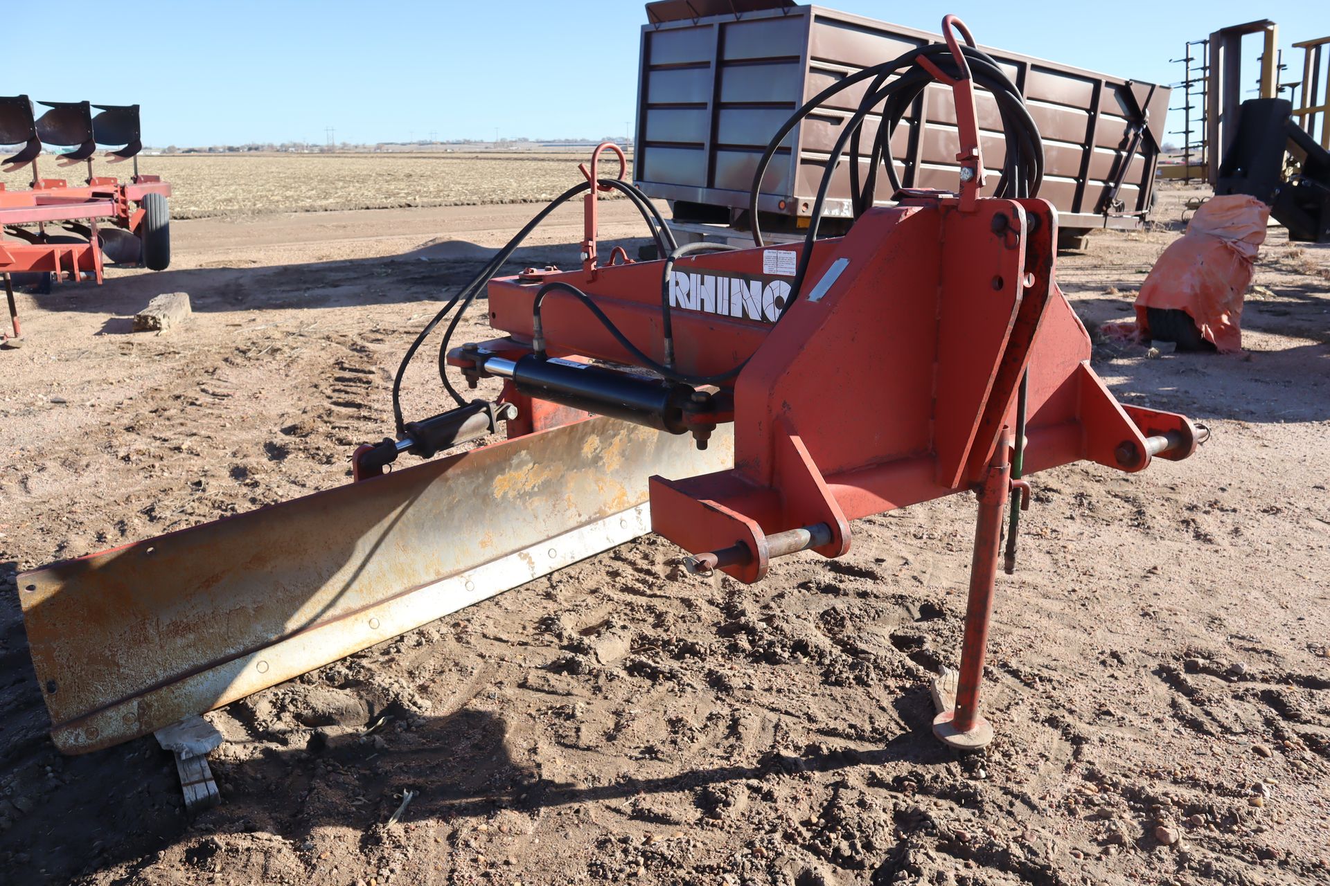 A red plow with the word rhino on it