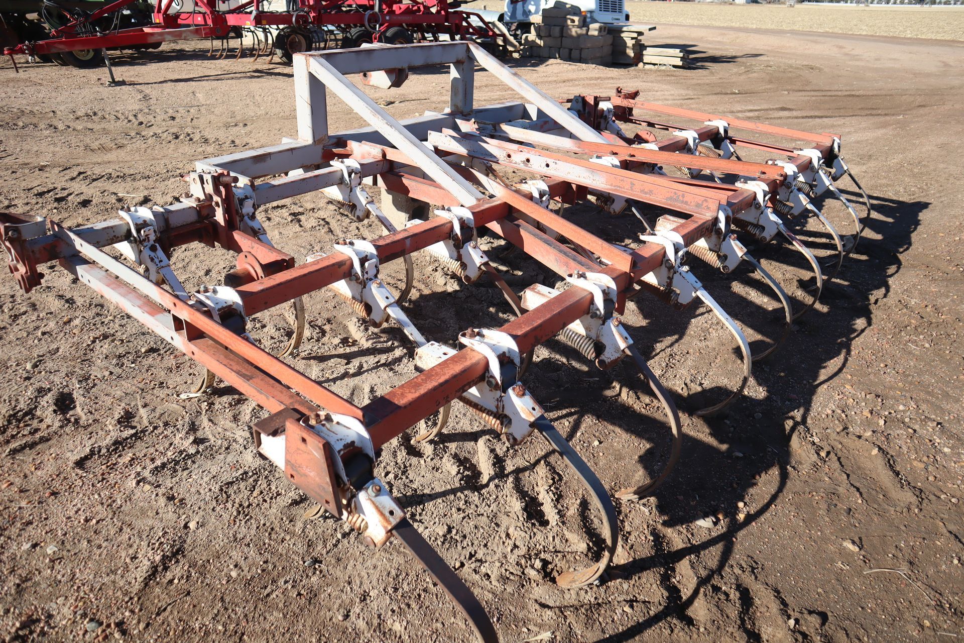 A large piece of machinery is sitting in the dirt