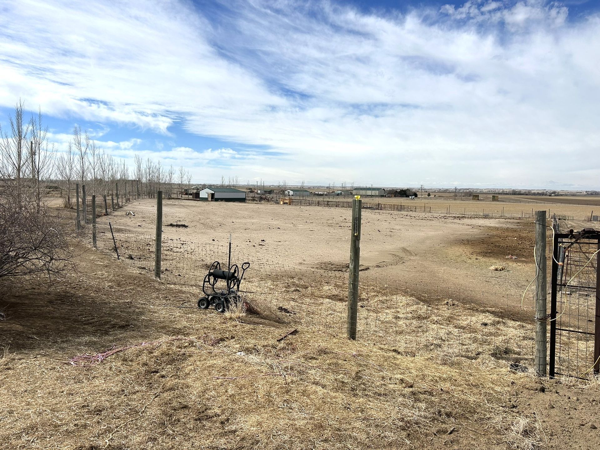 There is a fence in the middle of a field.