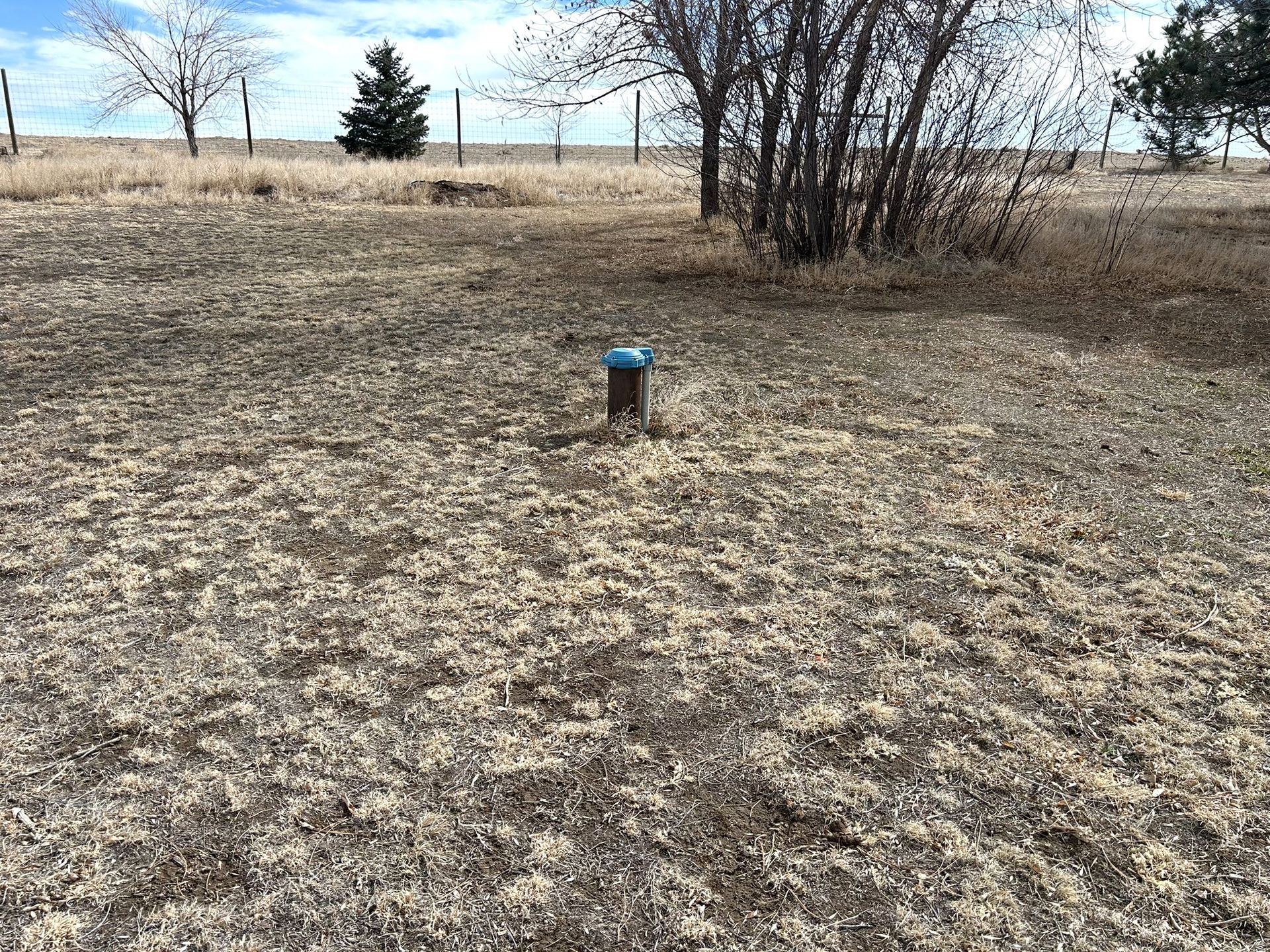 There is a blue pipe in the middle of the field.