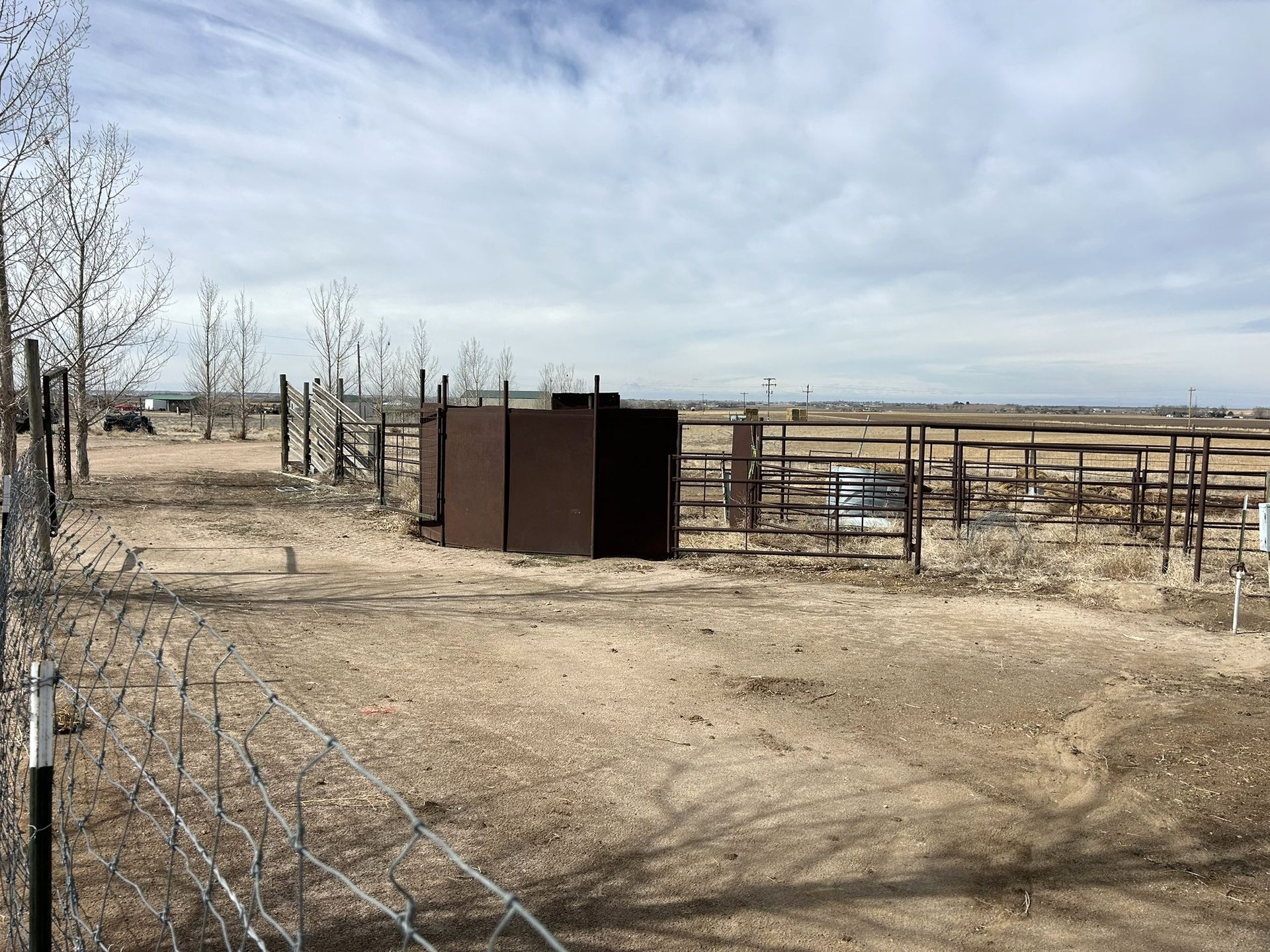 A fenced in area with a shed in the middle of it